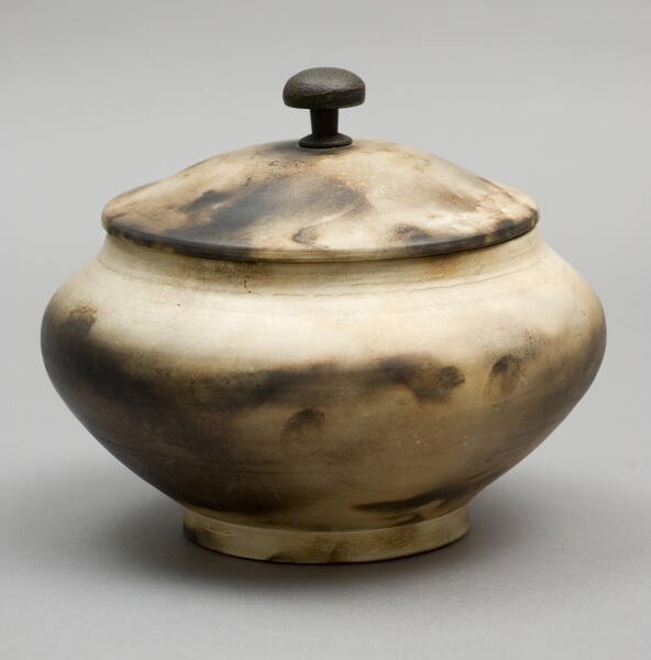 Urn decorated by smoke and sawdust