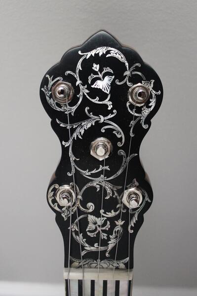Industrialist's Daughter Peghead of banjo with mother of pearl inlay and engraving.