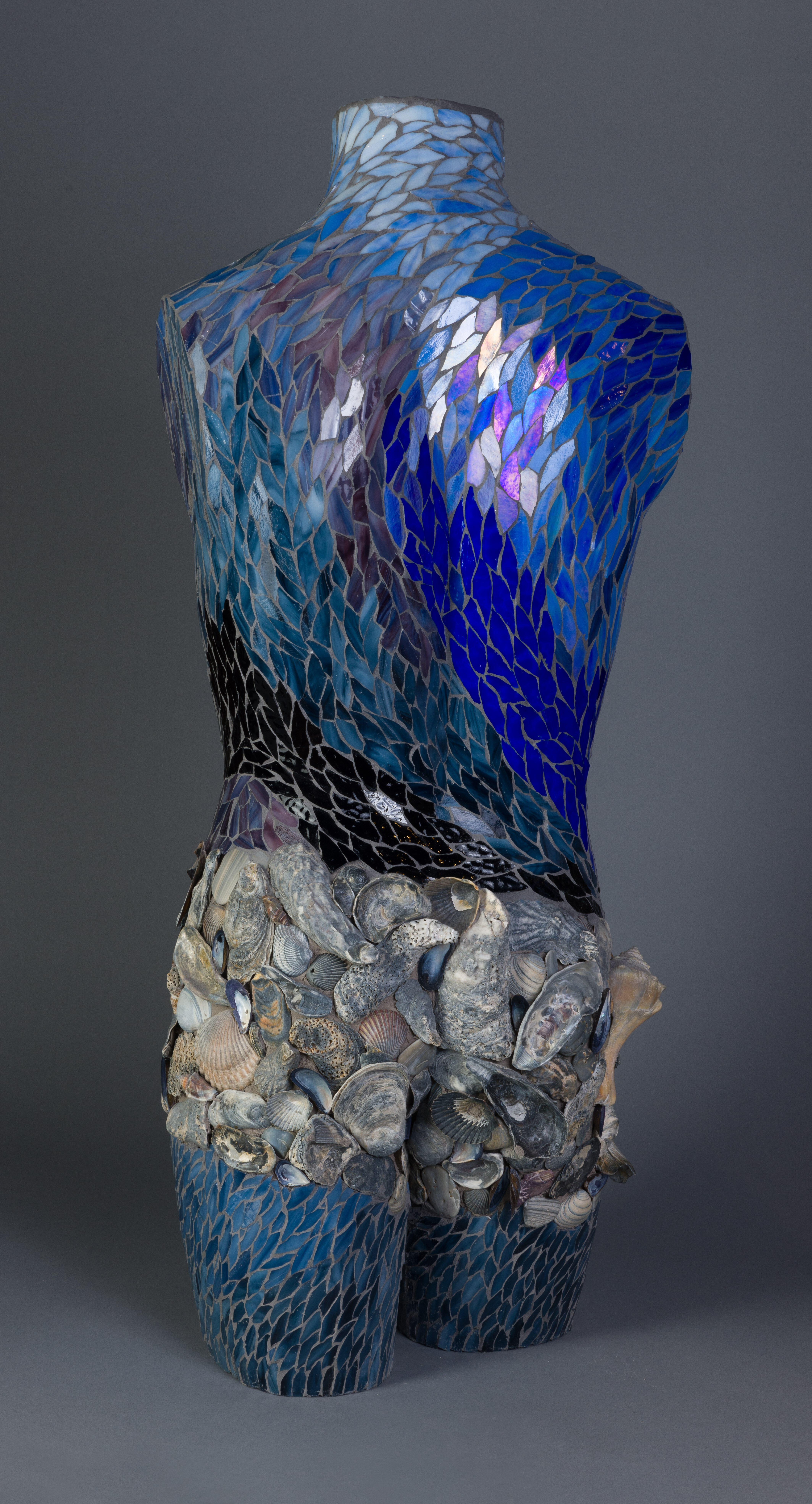3D life sized mannequin adorned with hand cut pieces of stained glass and shells 