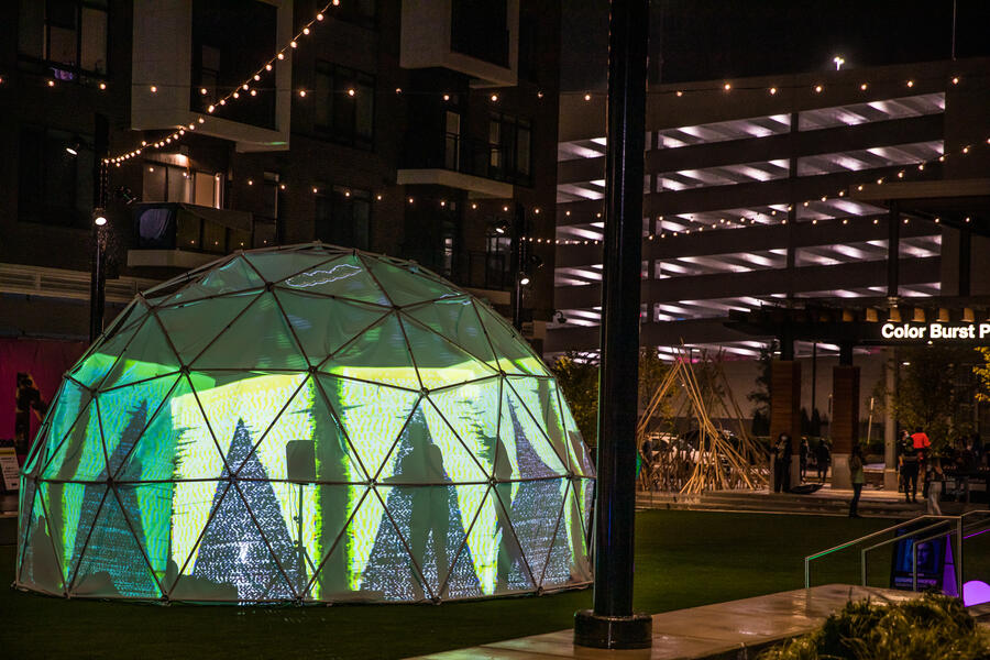 green neon abstract projections in a geodesic dome