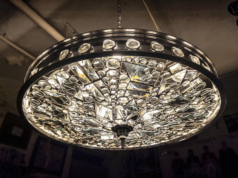 Light fixture chandelier made from clear glass and a bicycle wheel