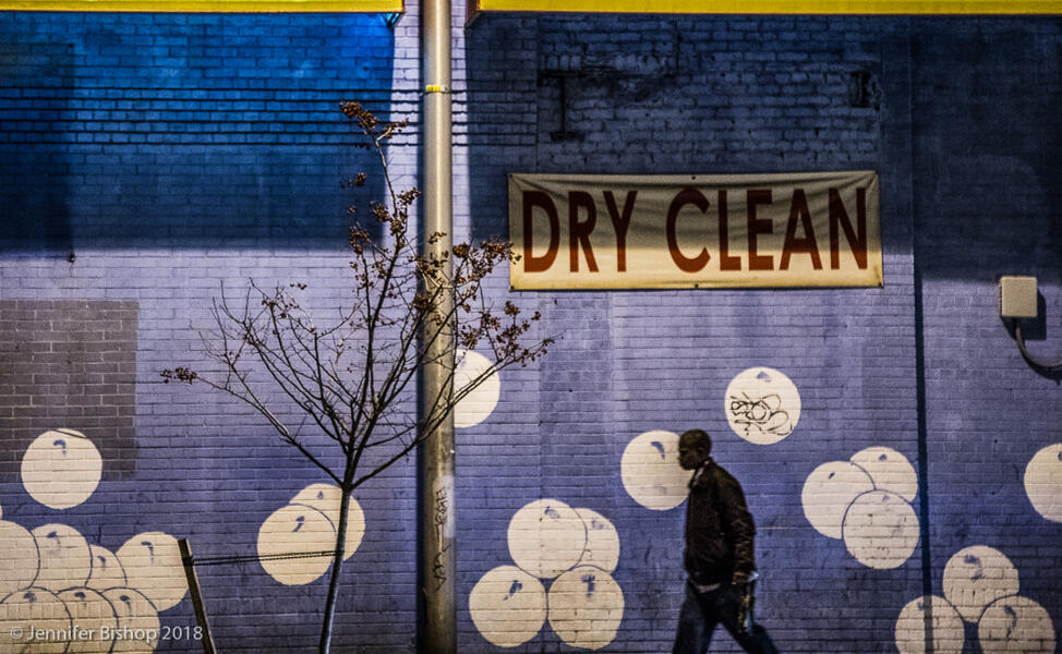 photograph of man walking by bubbles mural in Baltimore City