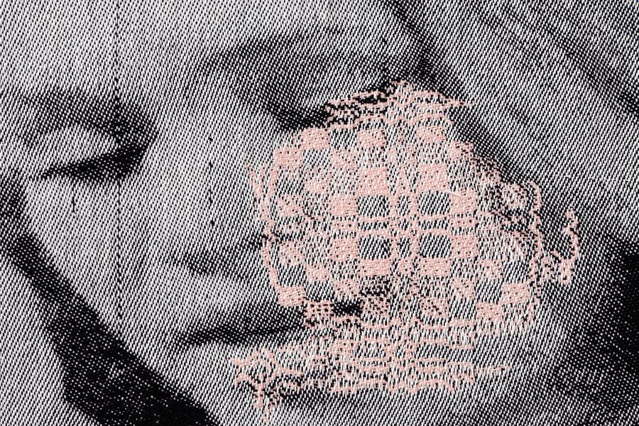 detail image of a woven portrait of a woman with a rosette pattern overlaid on her cheek 