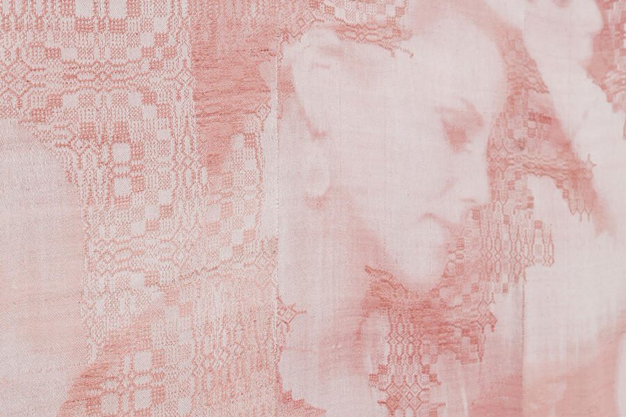 Detail of a woven portrait of a woman rejected from an episode of "The Bachelor" based on an inverted screenshot