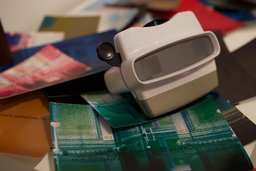 A viewfinder essay sits amid hand lettered 4 x 6 hand lettered images at the installation at School 33, Baltimore.