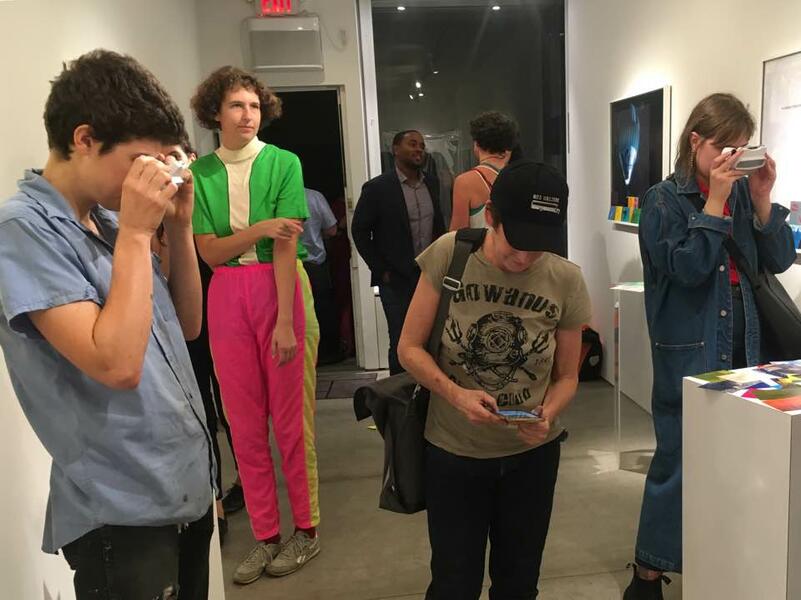  This is gallery shot at Capsule NYC shows visitors reading the 3d viewfinder essays.