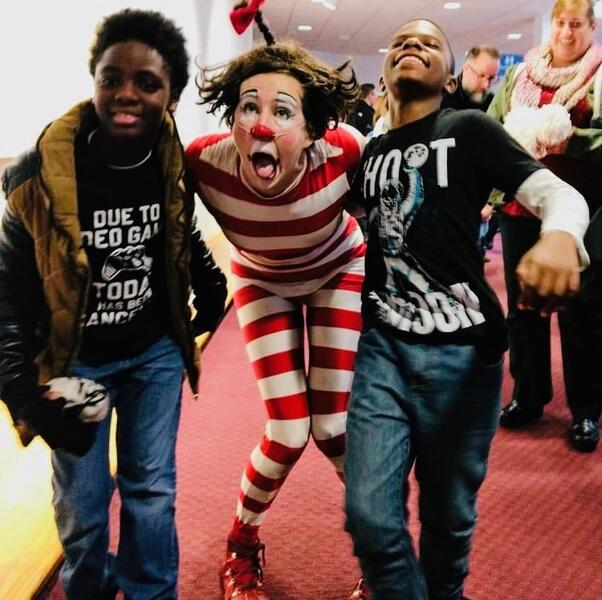 clown plays with kids
