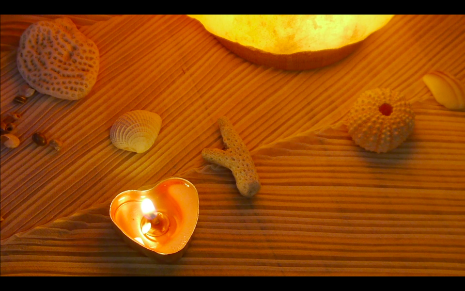 Image of seashells and candles on an alter dedicated to Amphritrite
