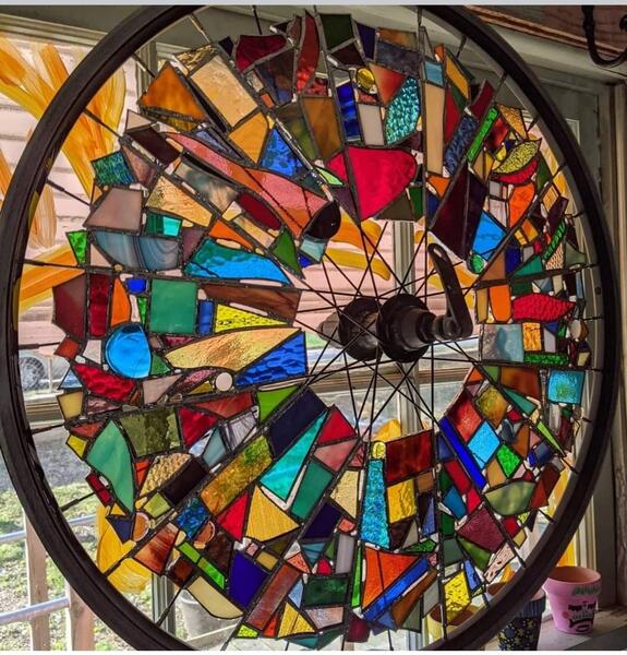 Abstract art made fom bicycle wheel and glass pieces