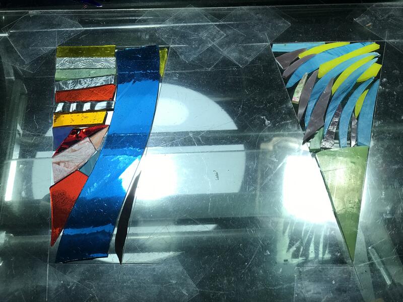 Pieces of colored glass aranged in a jig