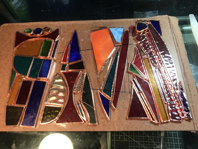 Glass pieces with edges wrapped in copper foil