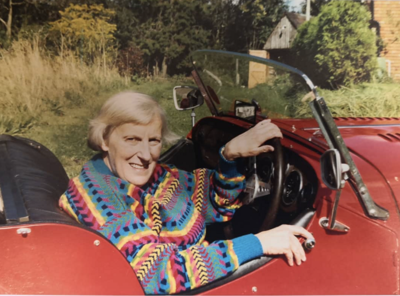 Ruth Gipps in red convertible