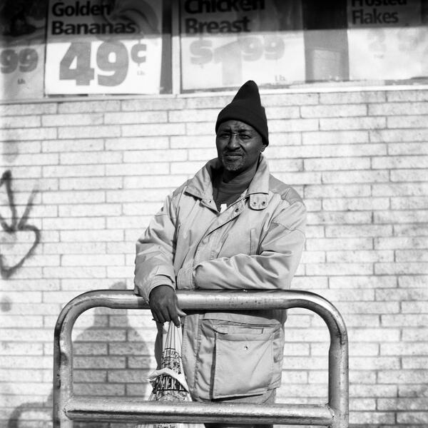 A man outside a grocery store in Fells Point.