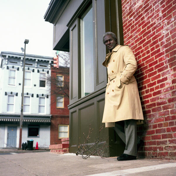 A man poses in Fells Point.