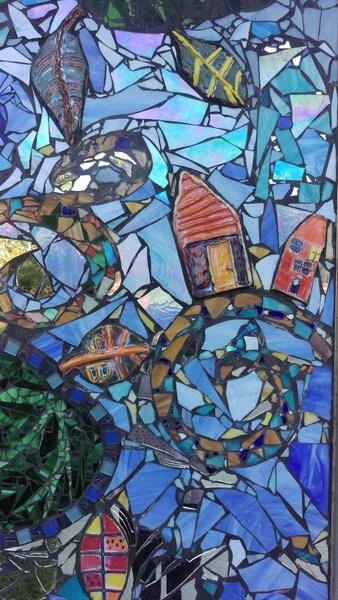 The mural was a combination of colored glass and ceramic tile. While I managed and facilitated over 20+ mosaic workshops in 2 months in the summer of 2011 there was another artist that facilitated the ceramic tile workshops with the youth at the school.