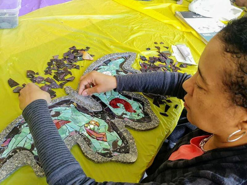 Participant working on mosaic butterfly. Butterflies ranges in size from 12x12 to 30x40.