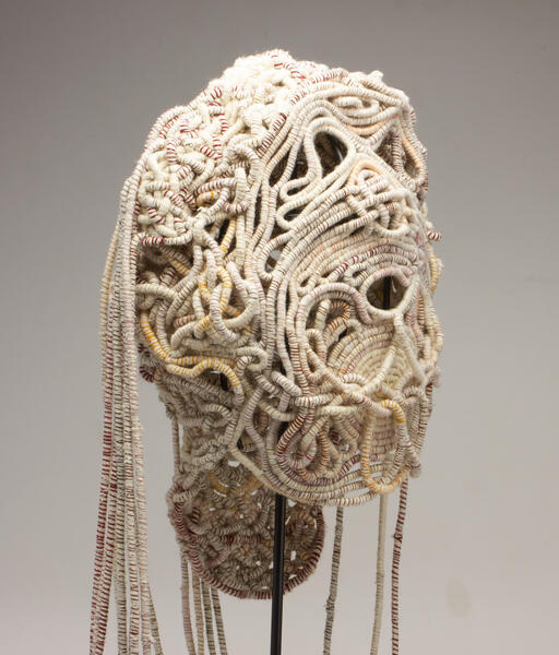 Coiled Mask 4 (profile), thread and rope, 2021, 60 x 15 x 11 inches