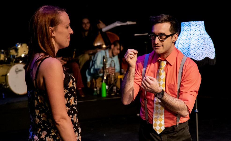 Magician speaks with volunteer.