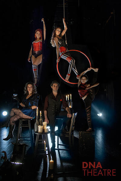 Circus performers pose with various apparatus.  