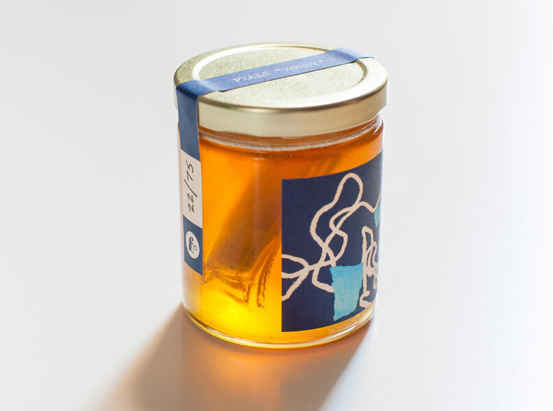 Honey in USB format submerged in a jar of raw honey