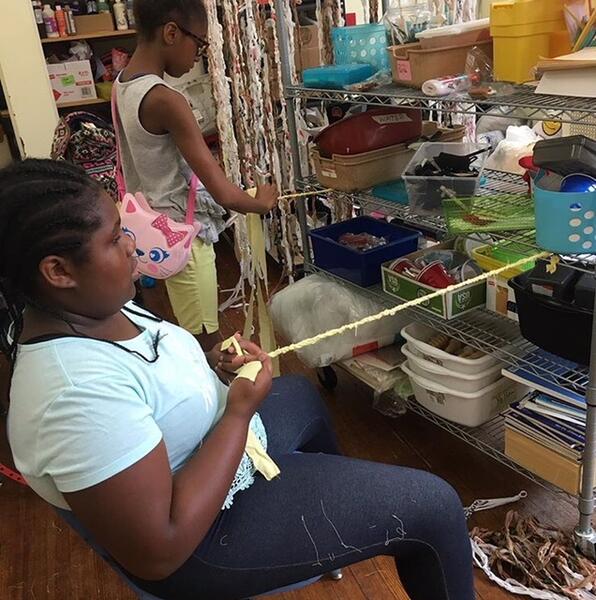 AFYA Girls braiding for The Twirling Tent