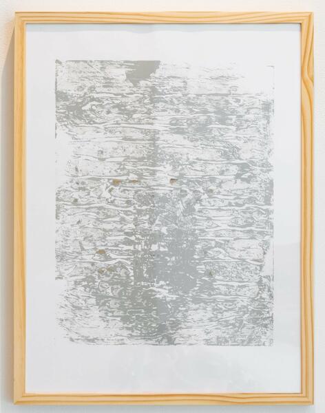 Gray textural print inside of a wood frame