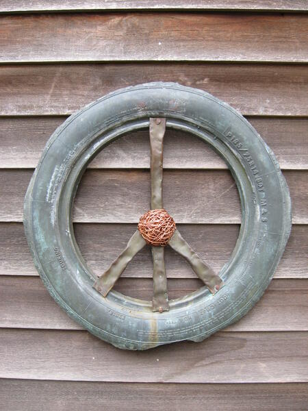 Bronze peace sign reinventing the wheel series. The interior symbol was created with beaten copper pipe.