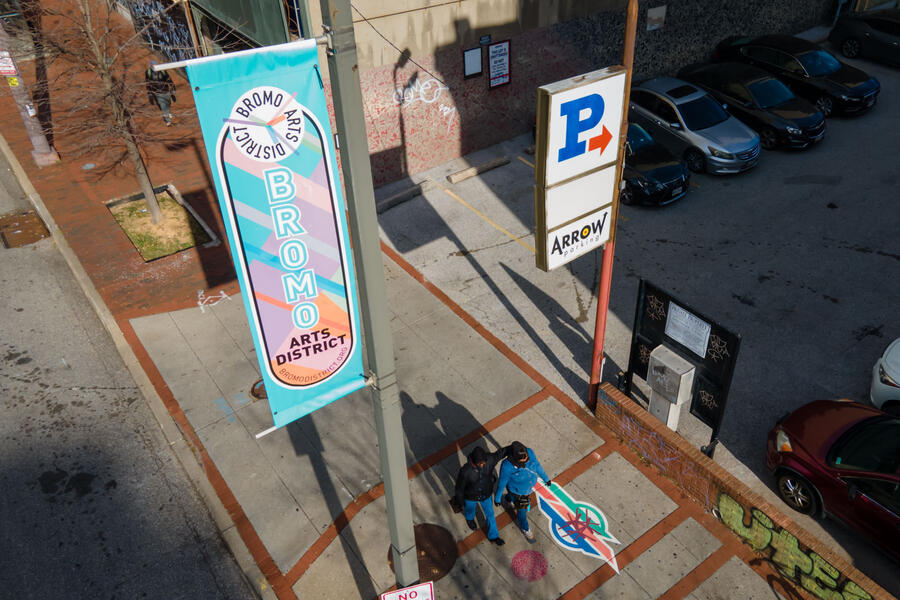 Bromo Wayfinding birds-eye view of Bromo Arts District marker with pedestrians